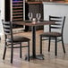 A Lancaster Table & Seating wood butcher block table with chairs set in a restaurant dining area.