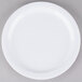 A white Carlisle Dallas Ware melamine plate with a white rim on a gray surface.