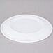 A white Carlisle Dallas Ware melamine plate on a gray surface.
