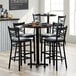 A Lancaster Table & Seating round bar height wood table with chairs around it.