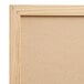 A close up of a black wall-mount chalkboard with a wood frame.