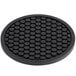 A black round Valor silicone trivet with hexagons in the design.