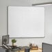A Dynamic by 360 Office Furniture whiteboard mounted on a wall.