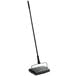 A black rectangular Lavex floor sweeper with a long handle.