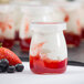 A close-up of a Tablecraft glass jar with strawberries and blueberries inside.