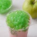 A green apple and a bowl of green jelly with a Bossen Green Apple Jelly topping.