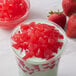 A bowl of strawberry heart-shaped jelly with red hearts on top.