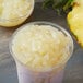 A bowl of pineapple jelly topping with white food.