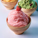 A close-up of a bowl of pink strawberry snow ice.