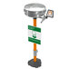 A Guardian Equipment pedestal mounted eyewash station with a stainless steel bowl and cover under a green and white sign.