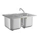 A Regency stainless steel double sink with faucet.