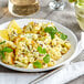 A plate of cauliflower with lemon and parsley on a table.