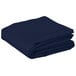 A folded navy blue rectangular Intedge table cover.