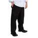 A man wearing Chef Revival black pants and a white shirt.