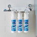 A group of C Pure Oceanloch-L3 water filtration systems mounted on a wall.