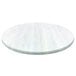 A white round table top with a white wood surface.