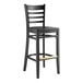 A Lancaster Table & Seating black wood ladder back bar stool with a black wood seat.