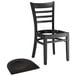 A Lancaster Table & Seating black wood ladder back restaurant chair with a detached black wood seat.