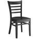 A Lancaster Table & Seating black wooden ladder back chair with a black seat.