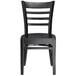 A Lancaster Table & Seating black wooden ladder back chair with black wood seat.