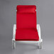 A white Lancaster Table & Seating chaise with red cushion and pillow.