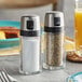 An OXO salt and pepper shaker set on a table.