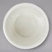 A white Thunder Group melamine ramekin on a gray surface.