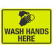 A yellow sign with black text and a hand washing