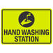 A yellow and black aluminum sign with the words "Hand Washing Station" and a symbol of a hand over a faucet.