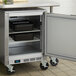 A Beverage-Air stainless steel undercounter freezer with a door open on a counter.