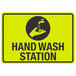 A yellow and black sign with a hand and a faucet and the words "Hand Wash Station"