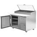 A Beverage-Air stainless steel refrigerated pizza prep table with a clear glass lid open.