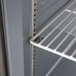 A white metal shelf in a Beverage-Air undercounter freezer.