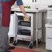 A man in a chef's uniform putting lemons in a Beverage-Air undercounter refrigerator.