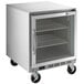 A Beverage-Air undercounter freezer with a glass door and shelves on wheels.