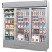 A Beverage-Air MarketMax stainless steel three section glass door merchandiser with a variety of products inside.