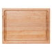 A John Boos maple wood cutting board with hand grips.
