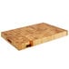 A John Boos maple wood cutting board with hand grips.