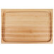 A John Boos maple wood cutting board with hand grips.