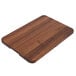 A John Boos black walnut wood cutting board with hand grips.