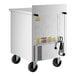 A stainless steel two-drawer worktop refrigerator on wheels with a power cord attached.