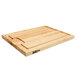 A John Boos maple wood cutting board with hand grips.