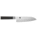 A Shun Classic Santoku knife with a black handle and white blade.