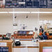 A Goff's clear PVC hanging partition on a white counter in a convenience store.