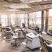 A Goff's clear PVC hanging partition with aluminum and fiberglass bars hanging in a room with chairs and computers.