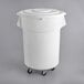 A white bucket on wheels with a lid.