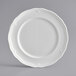 A white Acopa porcelain plate with a scalloped edge.