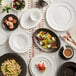 A table with a white Acopa Condesa saucer on it.