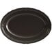 An Acopa Condesa matte black scalloped platter on a table.