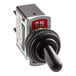 A close up of a black ServIt toggle switch with a red label.